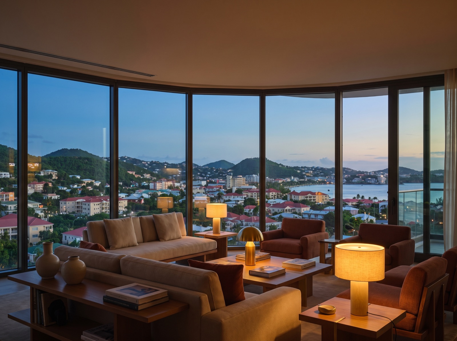 Condominium living room at dusk with a panoramic city and gulf view